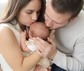 couple hugging baby scaled 1 couple hugging baby scaled 1